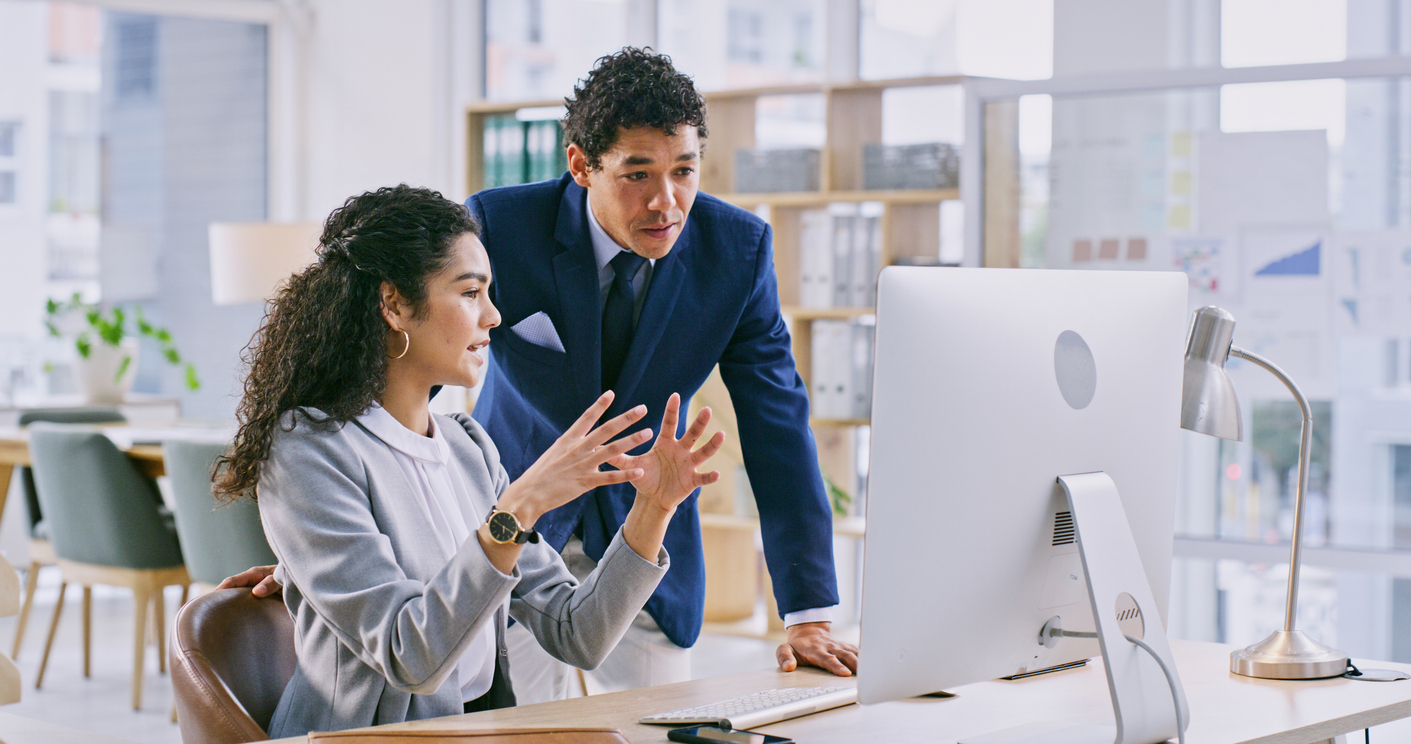 Two attorneys discussing Technology for Attorneys solutions at a modern law office, enhancing efficiency and collaboration.