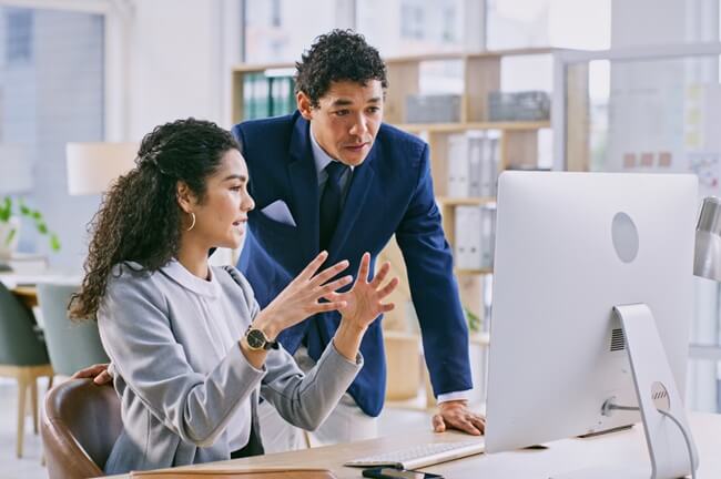 Two attorneys discussing Technology for Attorneys solutions at a modern law office, enhancing efficiency and collaboration.